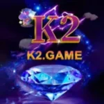 K2 Game logo featuring a sparkling blue diamond and purple lightning background.